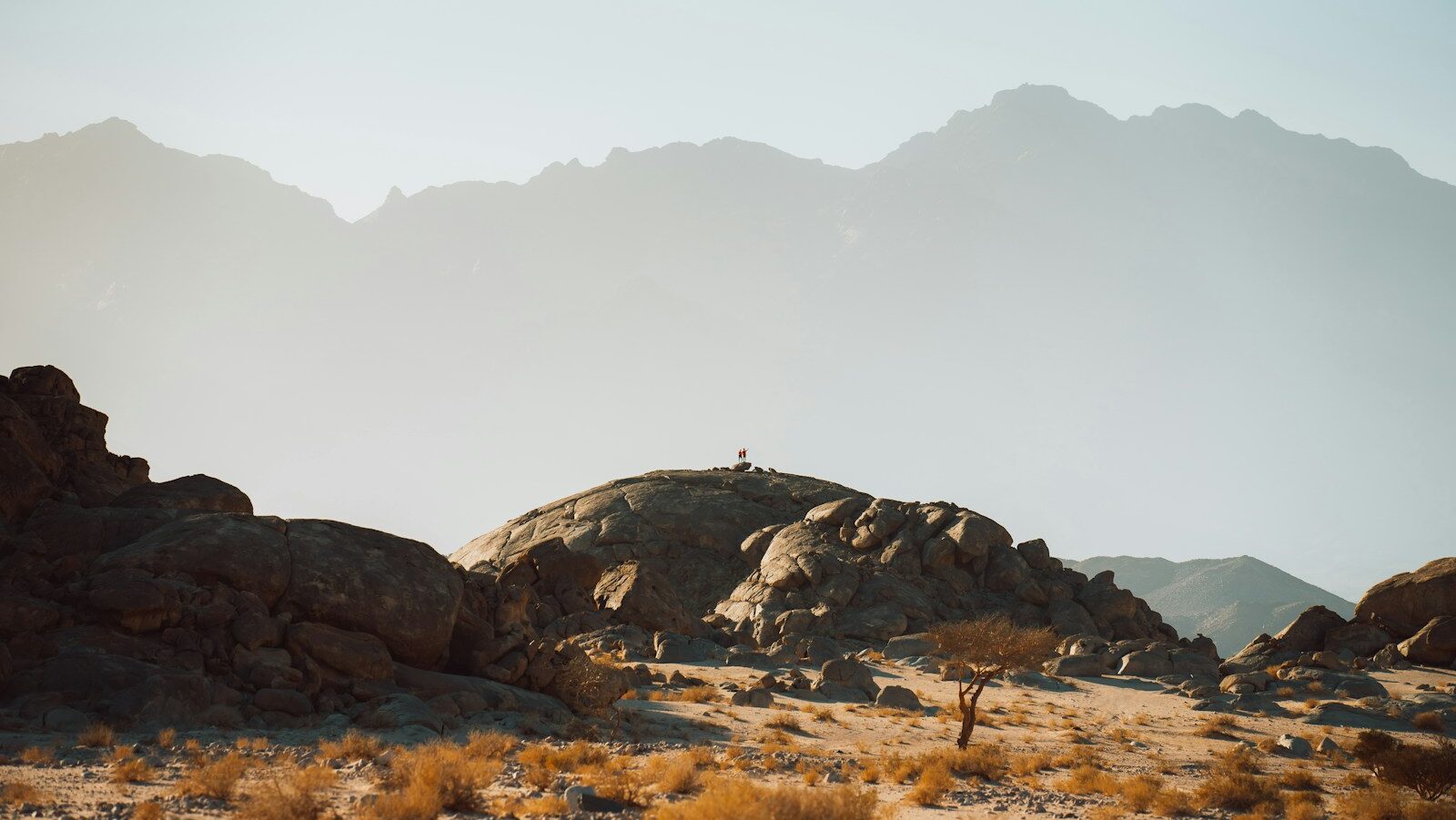 a person standing on top of a rocky hill