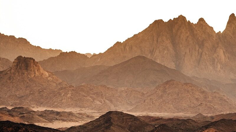 a desert landscape with mountains in the background