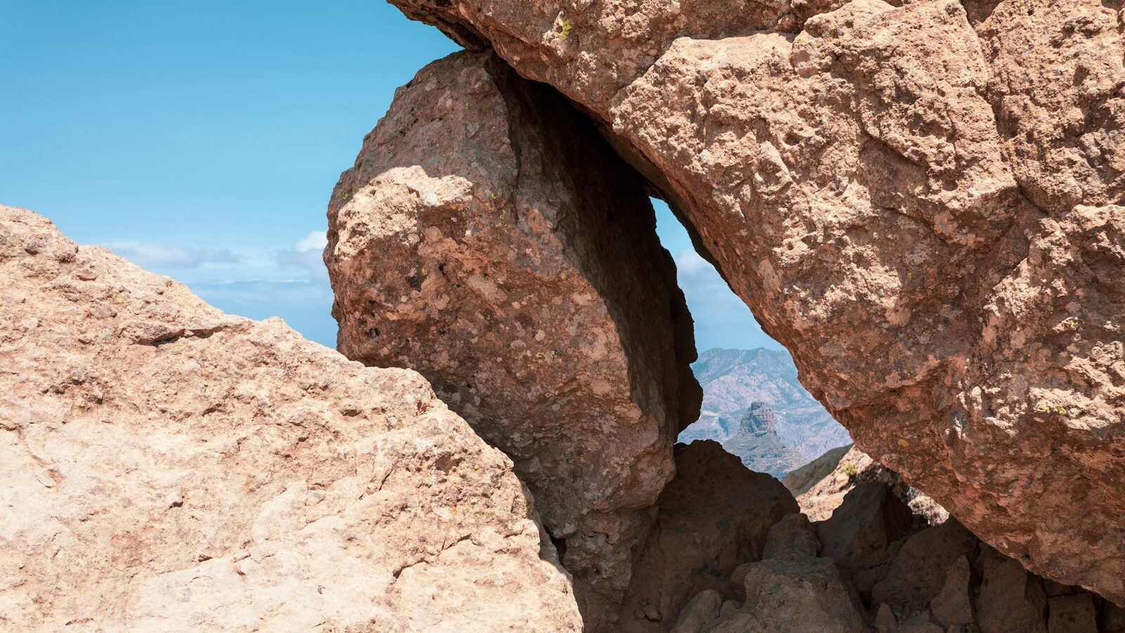 a person standing on top of a large rock